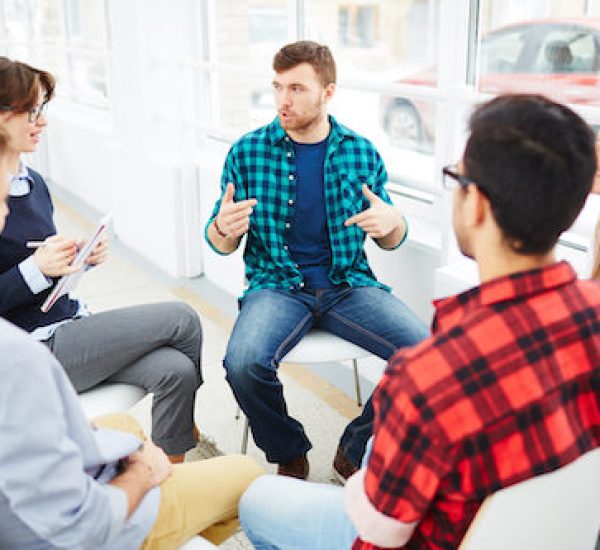 Therapist speaking to a rehab group at therapy session
